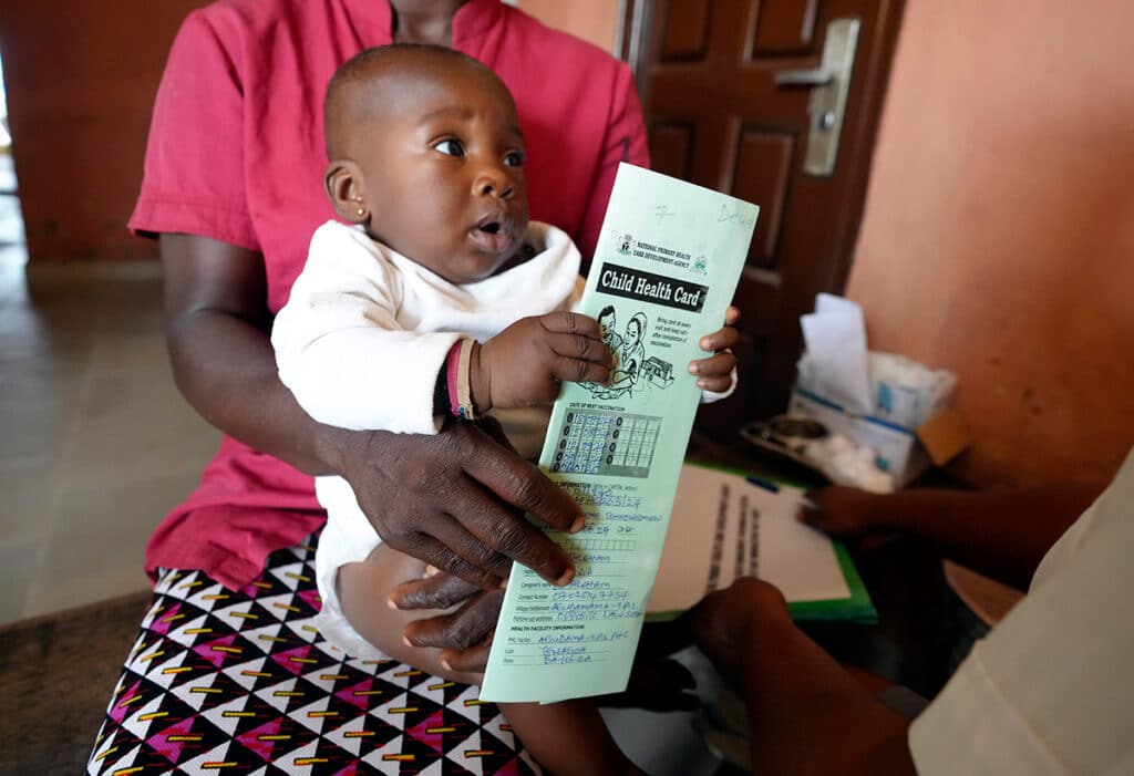 A woman waits to administer the malaria vaccine R21/Matrix-M to her child at the comprehensive Health Centre in Agudama-Epie, in Yenagoa, Nigeria, Monday, Dec. 9, 2024. (AP Photo/Sunday Alamba)