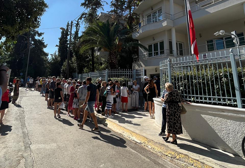 Citizens wait in a long line to vote at the Polish embassy in Athens, Greece.