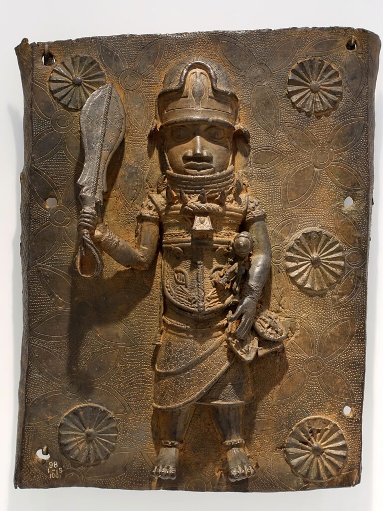 Photo of a Benin bronze plaque on display at a museum
