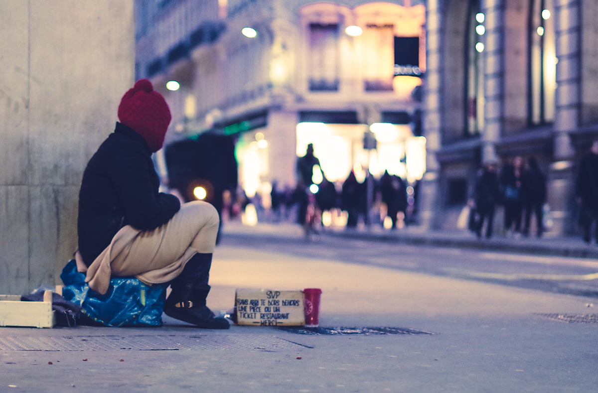Photo of a homeless person on a street corner