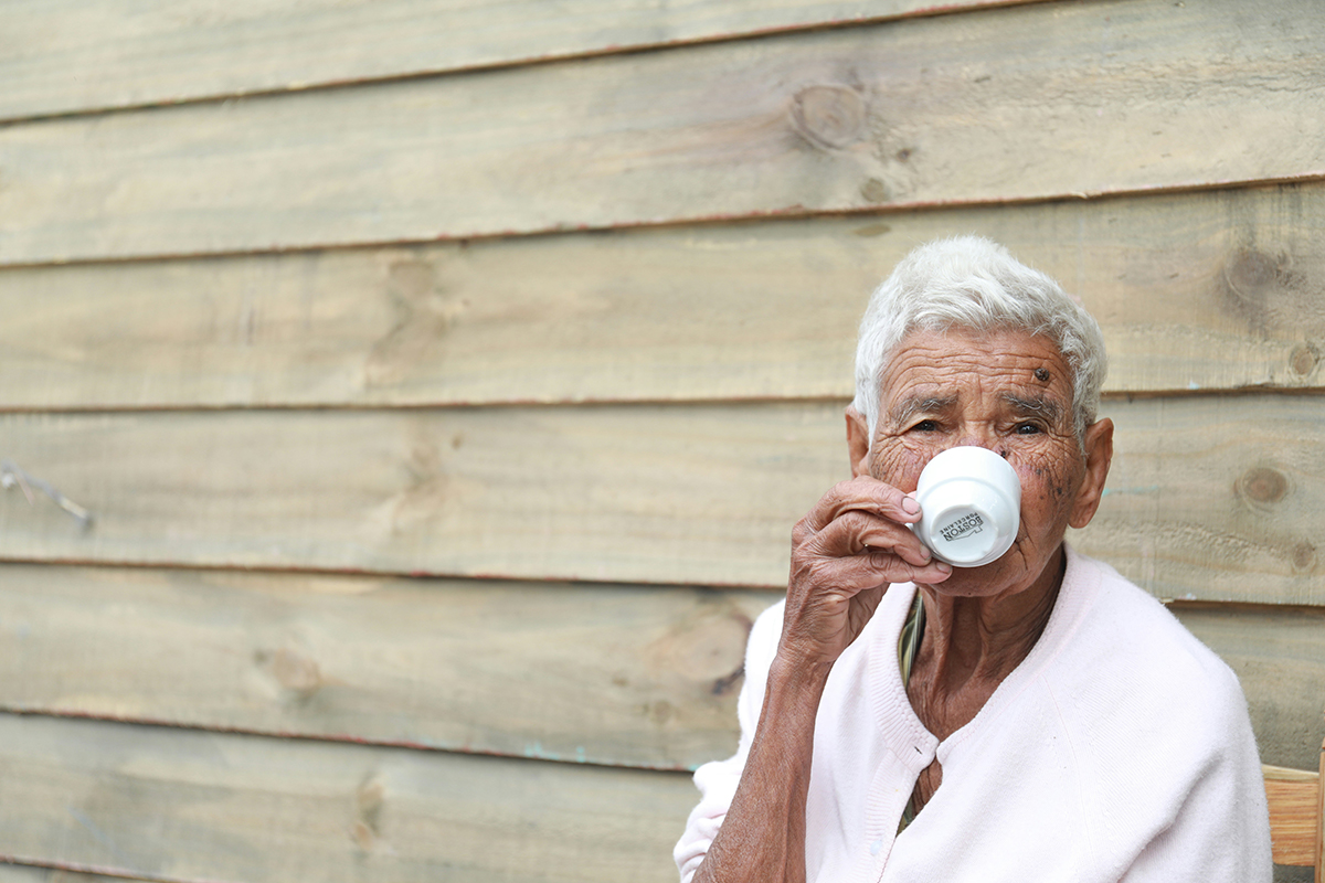 Photo of an elderly person drinking coffee