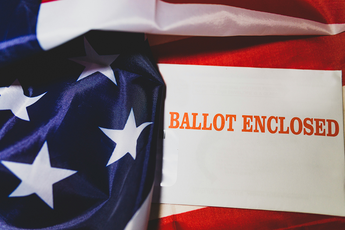 Photo of US flag and ballot envelope