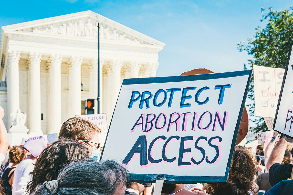 Abortion rights advocates hold a sign reading 'Protect Abortion Access' in front of the US Supreme Court Building