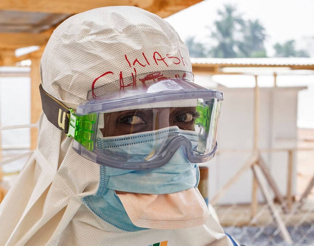 A health care worker wearing virus protective gear before entering a high risk zone at an Ebola virus clinic