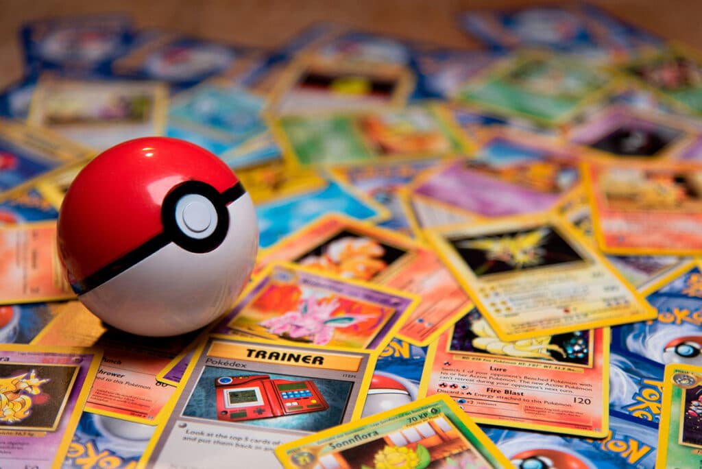 A classic Pokeball toy on a spread of Pokemon cards