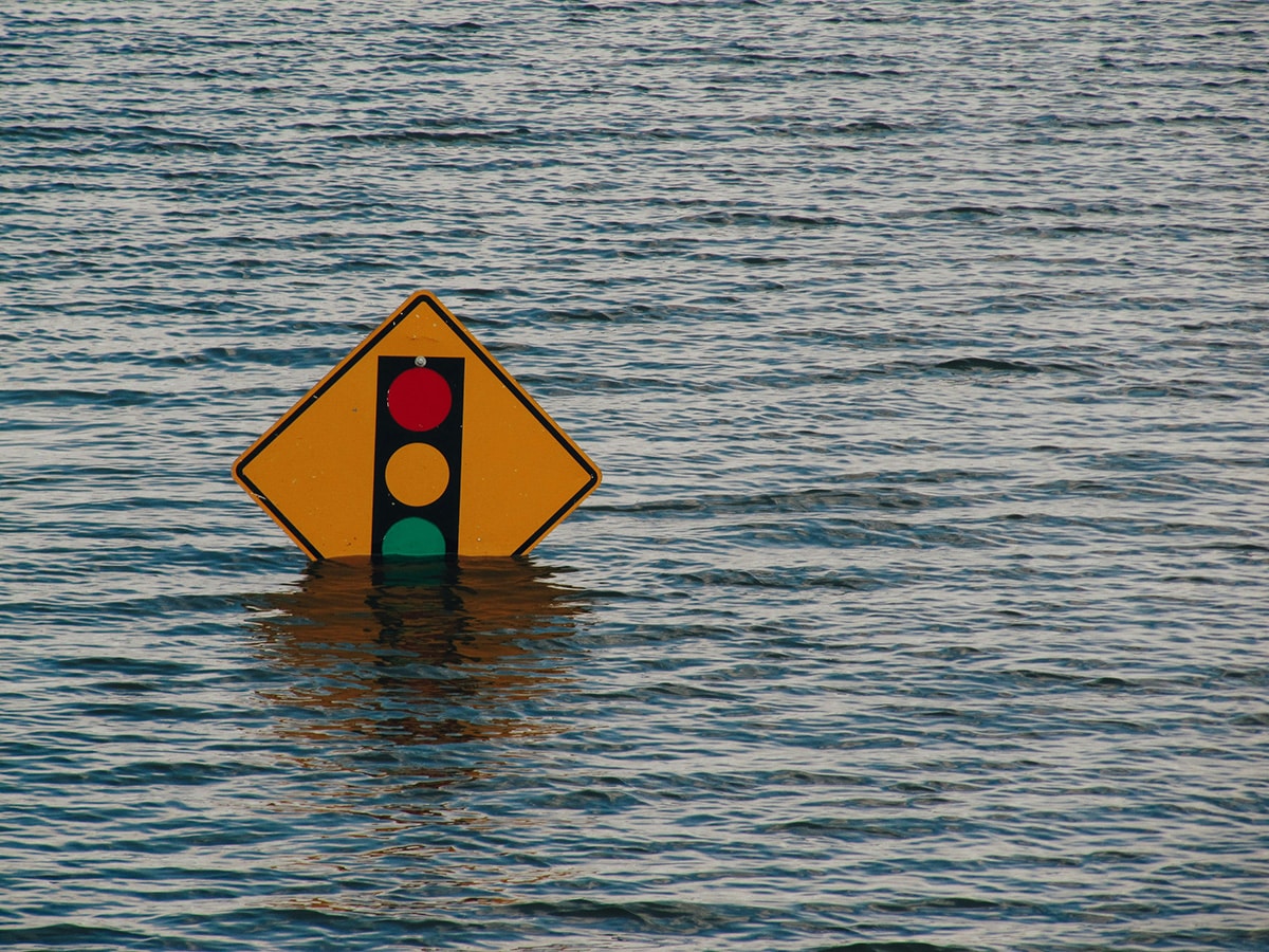 A road sign submerged in floodwater