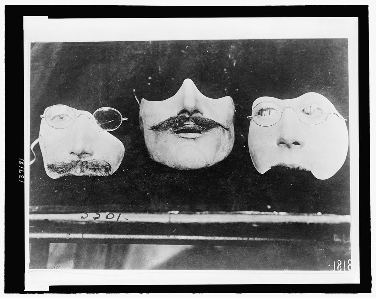 Historical photo from the early 20th century showing masks made for men with facial mutilations