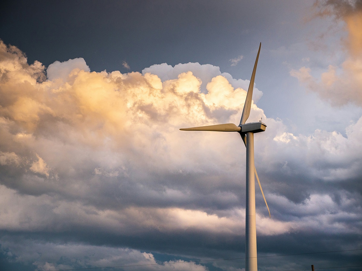 A wind turbine set against a stormy Oklahoma sky