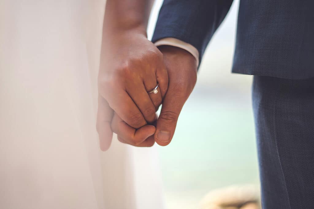 A bride and groom holding hands