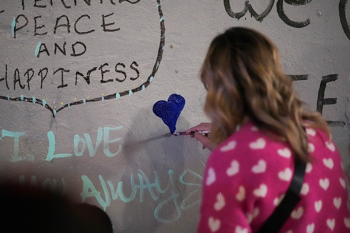 A woman at a memorial for the victims of a deadly truck attack in New Orleans, January 2025 | AP Photo / Gerald Herbert